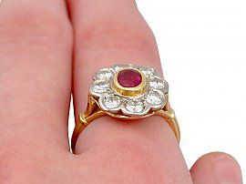 ruby and diamond cluster ring on finger