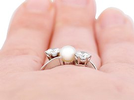 diamond and pearl ring on finger