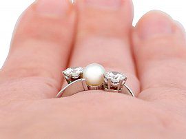diamond and pearl ring on finger