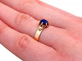 blue sapphire and pearl ring on finger