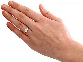 wearing platinum round diamond engagement ring