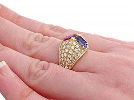 sapphire and ruby ring on finger
