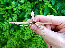 gold dragonfly brooch outside