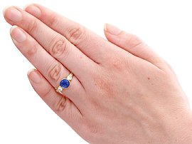 sapphire cabochon ring with diamonds wearing
