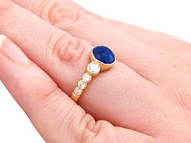 wearing sapphire cabochon ring with diamonds