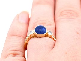 sapphire cabochon ring with diamonds wearing