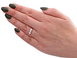 wearing a three stone diamond ring