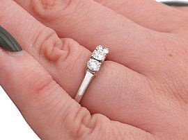 wearing a three stone diamond ring