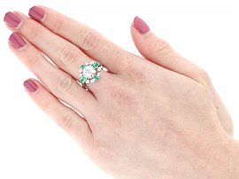 wearing diamond and emerald ring