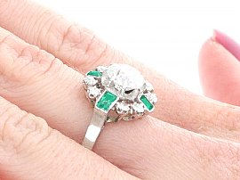 side view wearing diamond and emerald ring