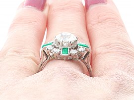 close up wearing diamond and emerald ring