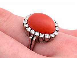 coral ring on the hand