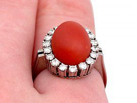 coral ring on hand close up