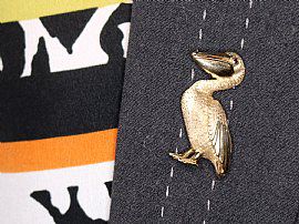 wearing vintage gold pelican brooch
