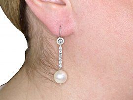 wearing pearl earrings