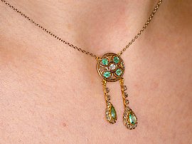 wearing antique emerald and diamond pendant