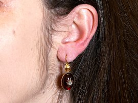 wearing a garnet earring