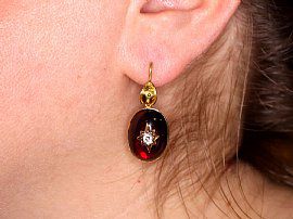 wearing a garnet earring
