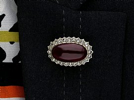 wearing a garnet brooch