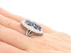Blue Sapphire and Diamond Cluster Ring on fInger