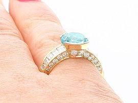 Aquamarine Ring with Baguette Diamonds on Finger