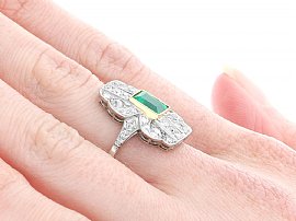 Emerald Cut Ring with Diamonds on the Hand