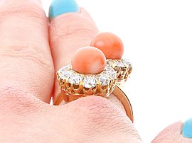 Antique Rose Gold and Coral Being Worn on the Hand