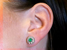 Vintage Emerald and Diamond Cluster Earrings Being Worn