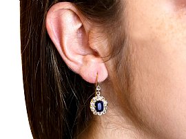 Blue Sapphire Dangle Earrings in Gold wearing