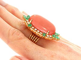 Coral Ring with Emeralds and Diamonds on the Finger