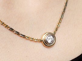 Wearing Bezel Set Diamond Pendant in Gold