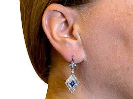 lozenge cut sapphire earrings with diamonds wearing 