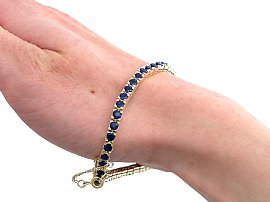 Sapphire tennis bracelet in gold wearing