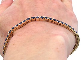 Sapphire tennis bracelet in gold wearing