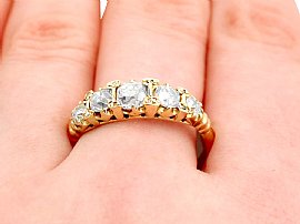 wearing five stone diamond ring yellow gold