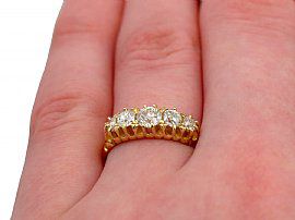antique five stone diamond ring on the finger